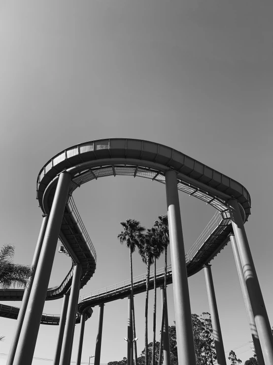 a long roller coaster going up hill in a theme park