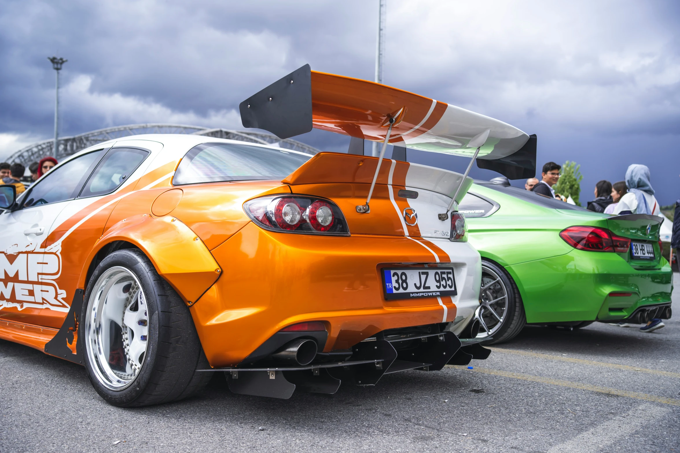 a sports car with a surf board strapped to the tail