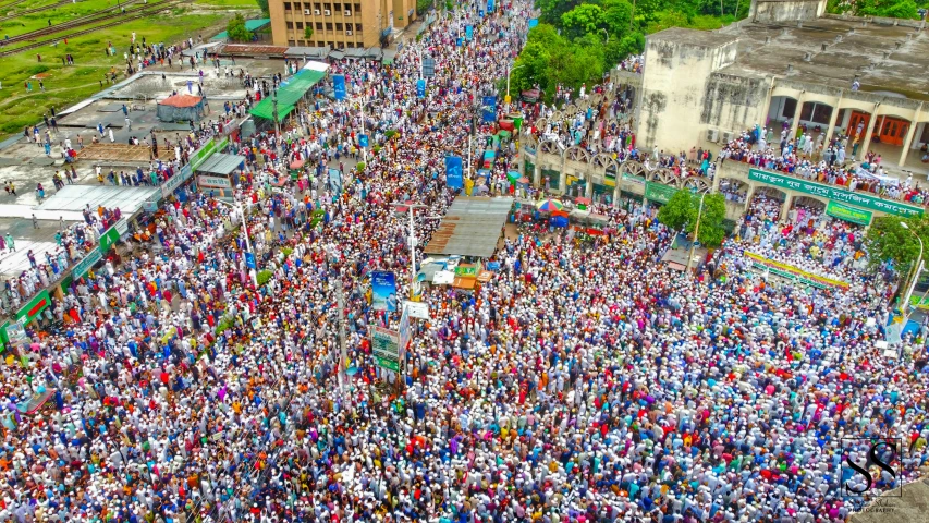 large group of people stand in the middle of a street