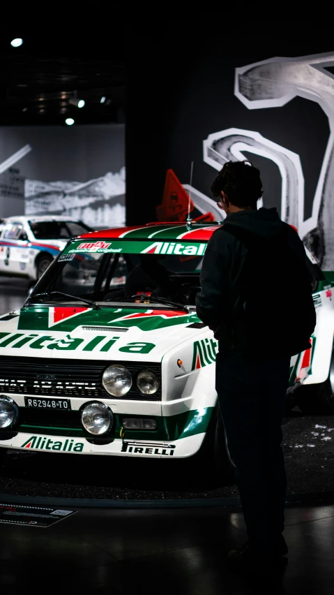 the car is in a museum with other cars in the background