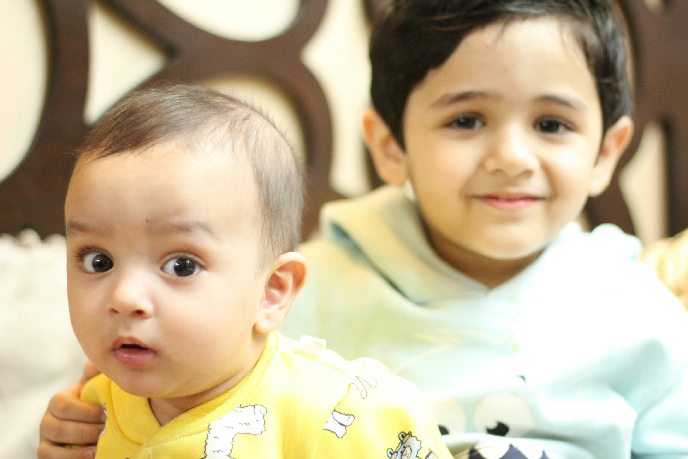 the two children are very adorable and looking at the camera