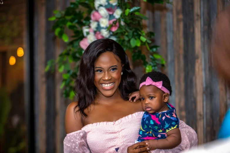 a woman holding a child and smiling at her