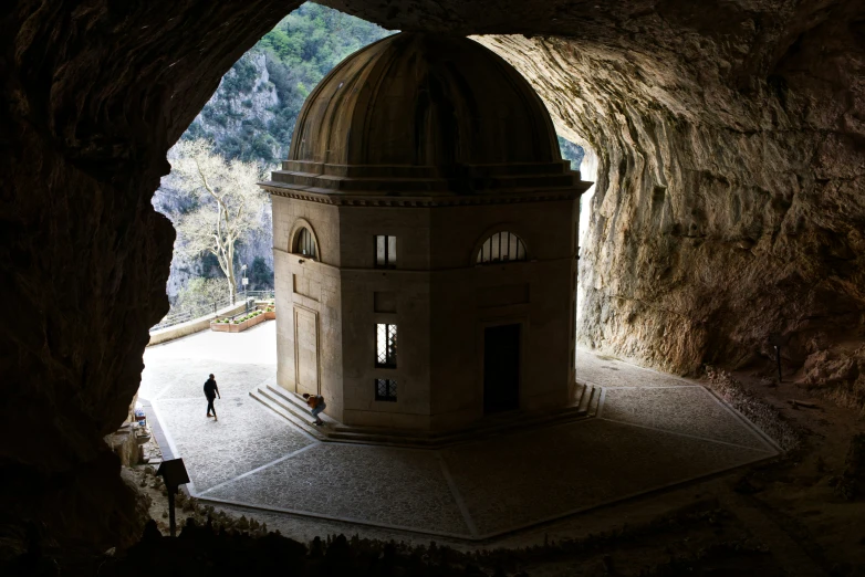 a small church nestled in the side of a cliff