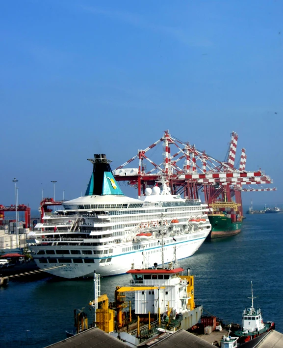 a large ship is parked near a large port