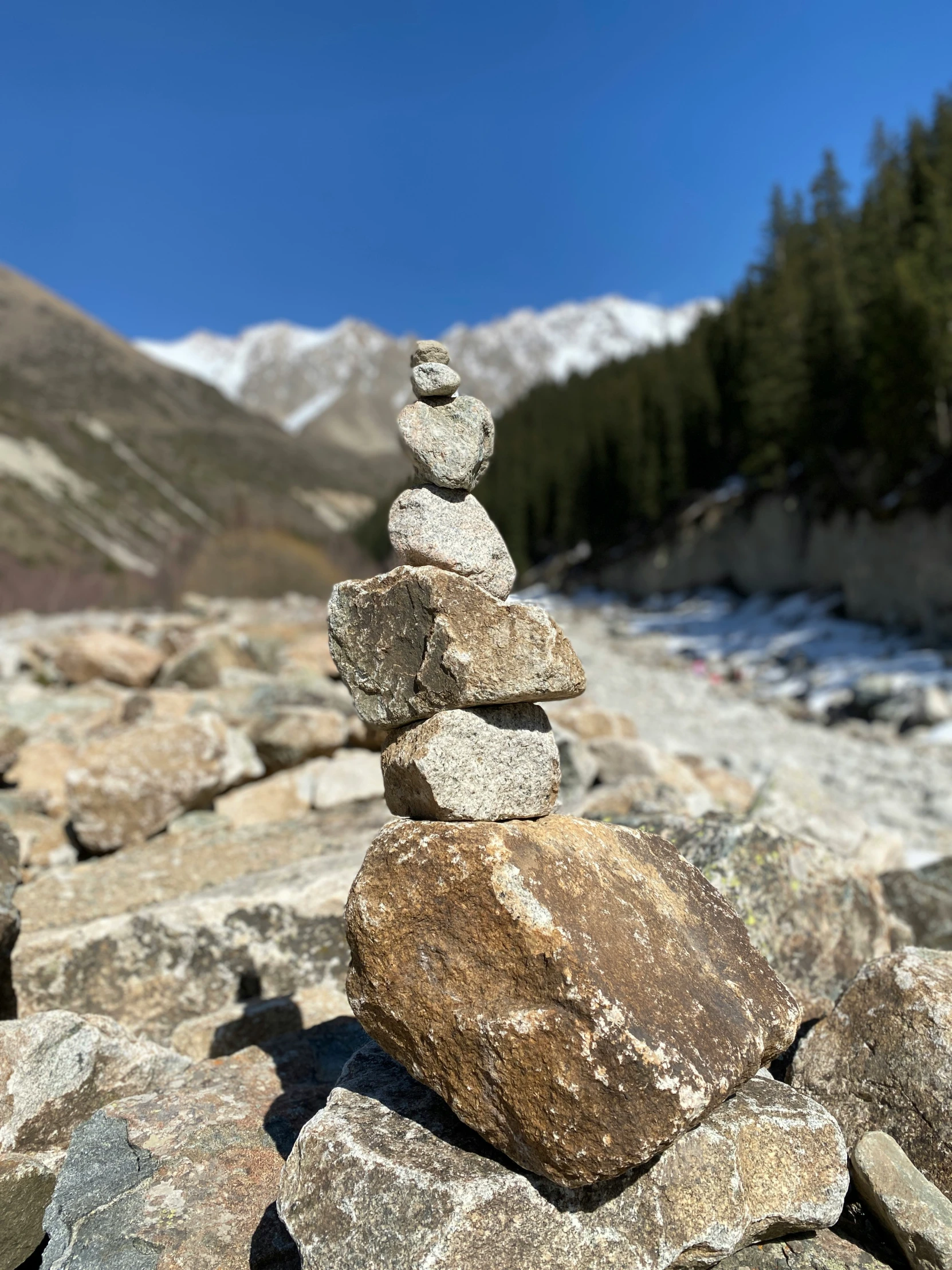 a pile of rocks on the side of a river