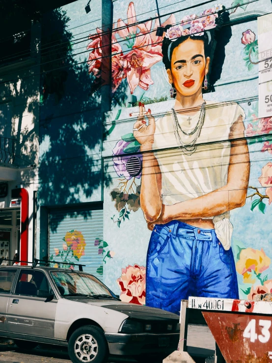 a street scene with a large painting on the side of a building