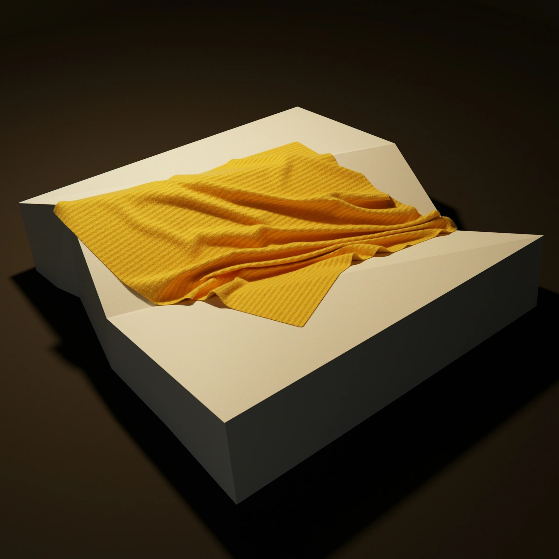 folded yellow cloth folded on white box, dark background