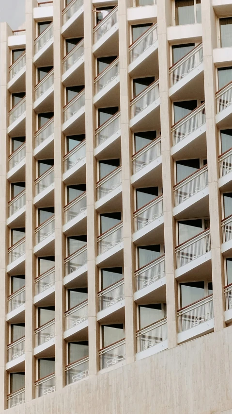 a tall building with balconies and some windows