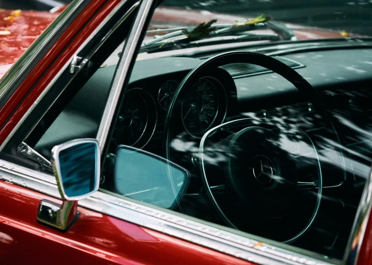 a car with its steering wheel visible sitting in a parking lot