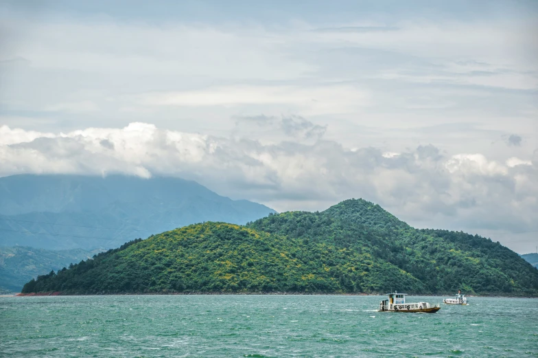 a small boat on a river with a island in the background