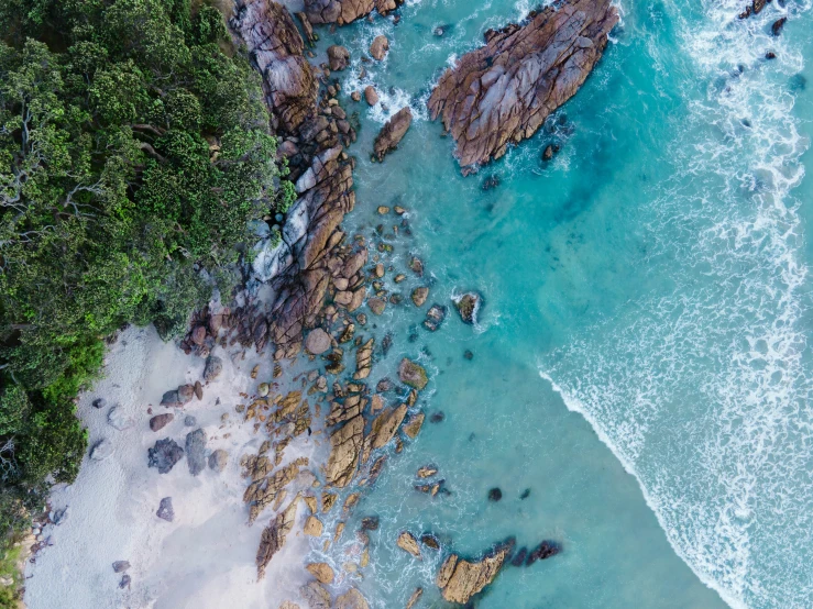 an aerial po of some blue water and rocks