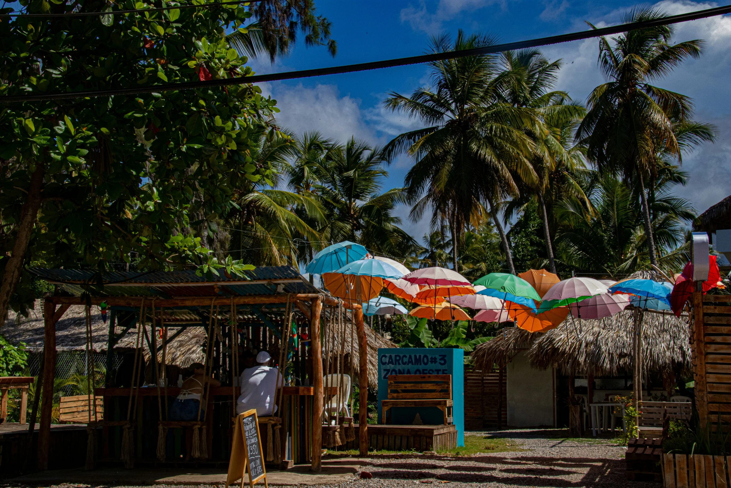 some umbrellas are sitting on the beach near water