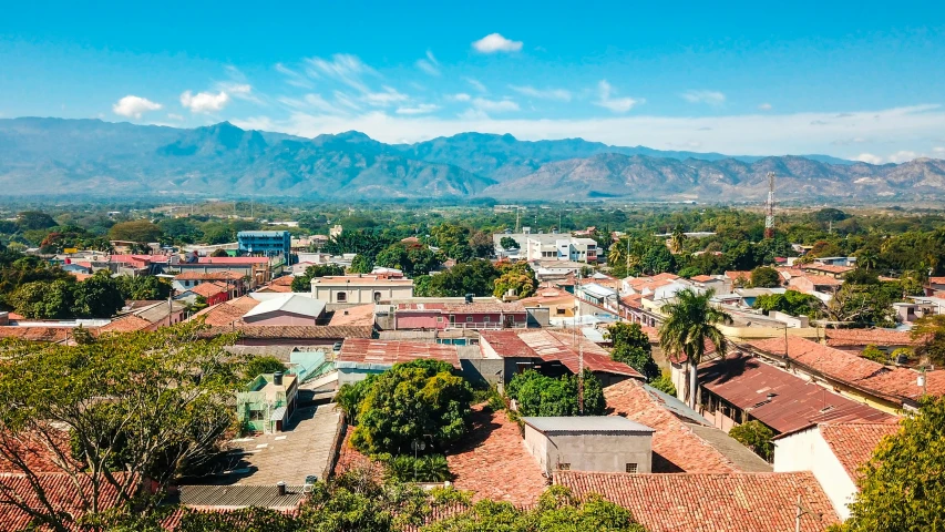 the roofs of buildings with mountains in the background