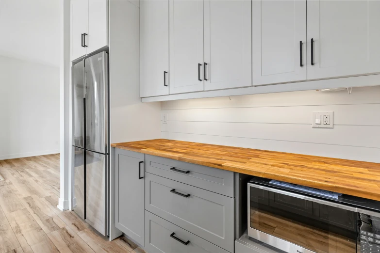 the kitchen is large and has white cupboards