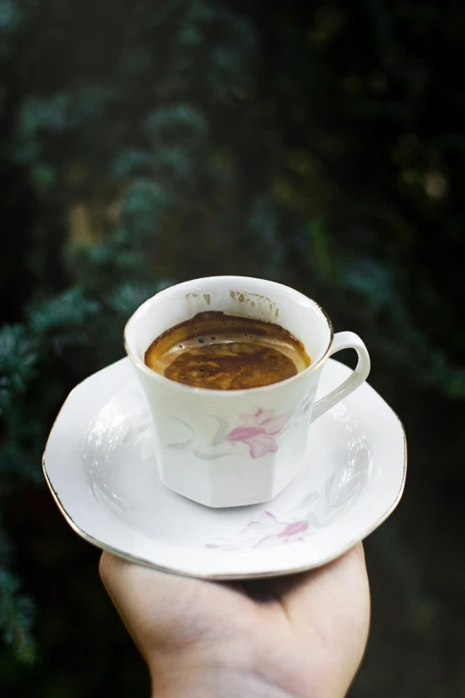 a white cup of coffee sitting on top of a saucer