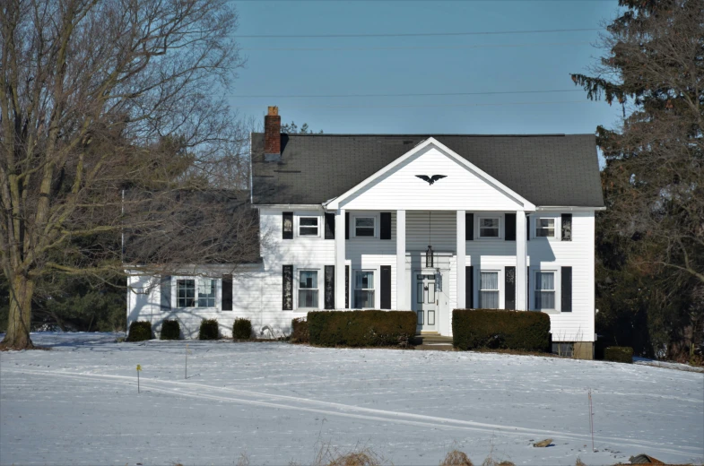 a house with black dorme windows and white sidings