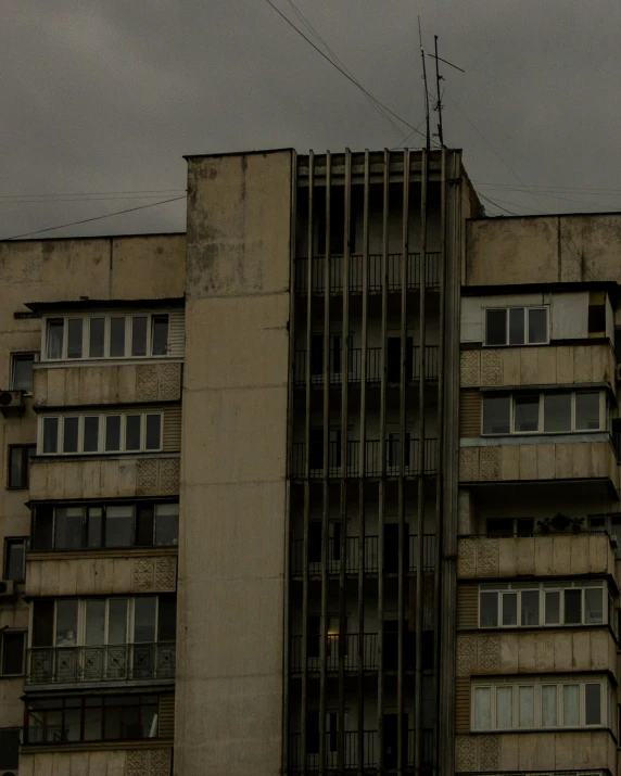 the building is tall, surrounded by dark clouds