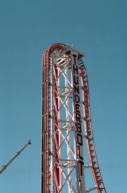 an amut park rides through the blue sky