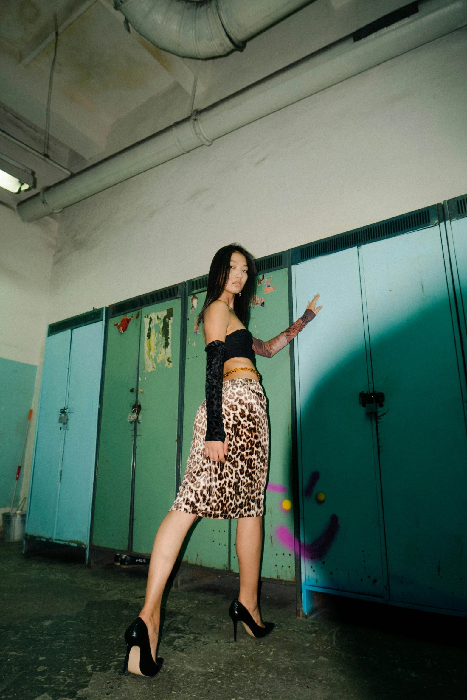 a girl leaning against a lockers in the middle of the day