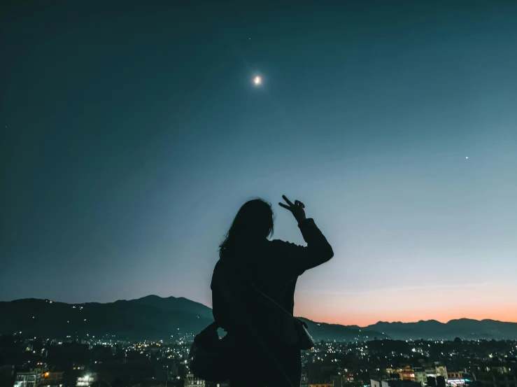 the silhouette of a person taking a po in front of a sun