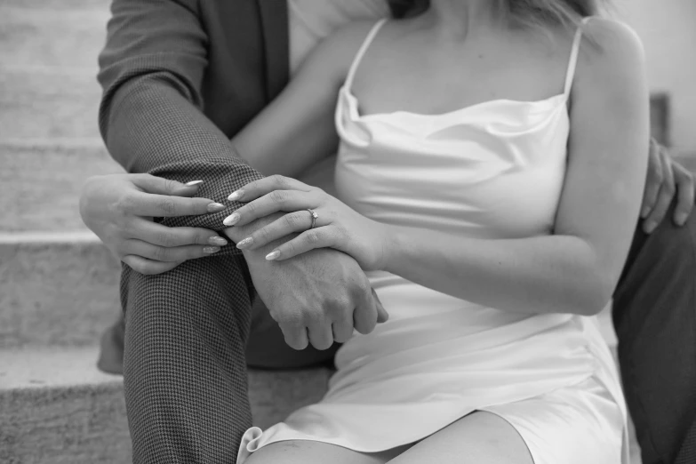 a man and woman sitting next to each other on steps