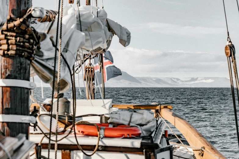 an orange life vest hangs from the side of a boat