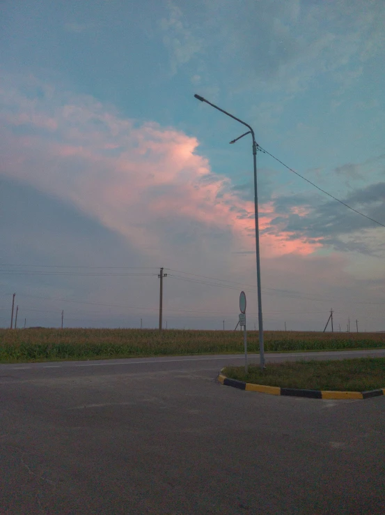 a street light is sitting in the middle of the open road