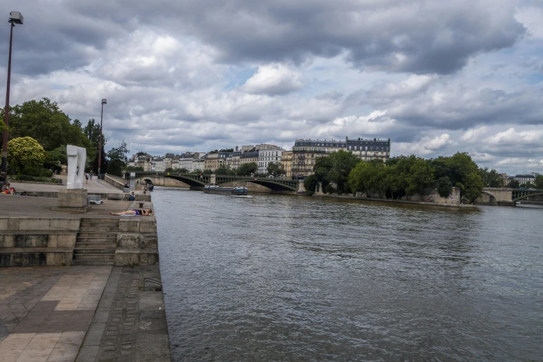 a waterway in the city next to a large building