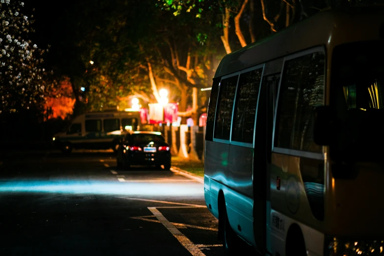 two cars are driving past a bus on a street