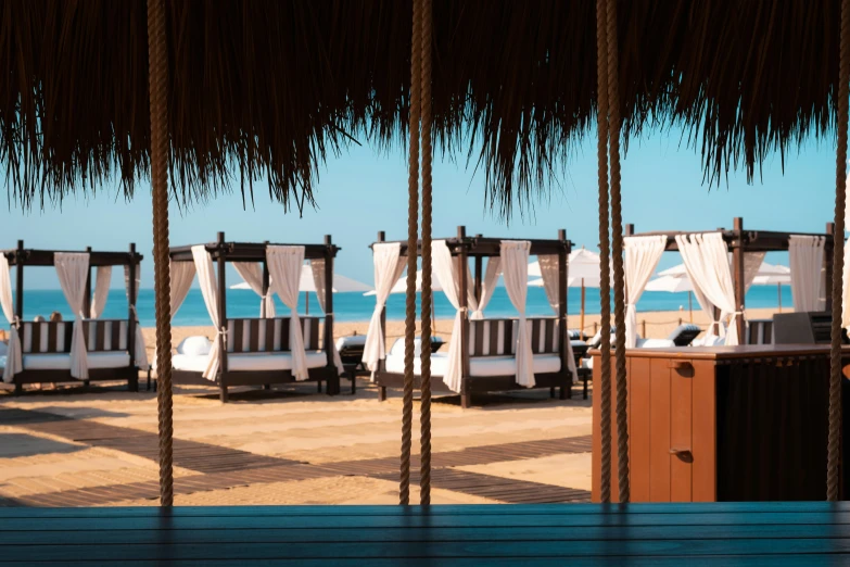 view out into the ocean through cabanas to beach huts