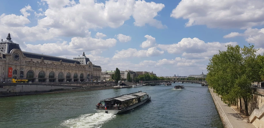 a large boat cruises on a canal in europe