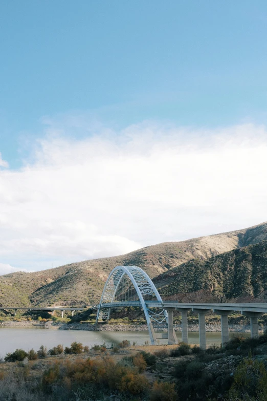 the blue bridge is going over the water