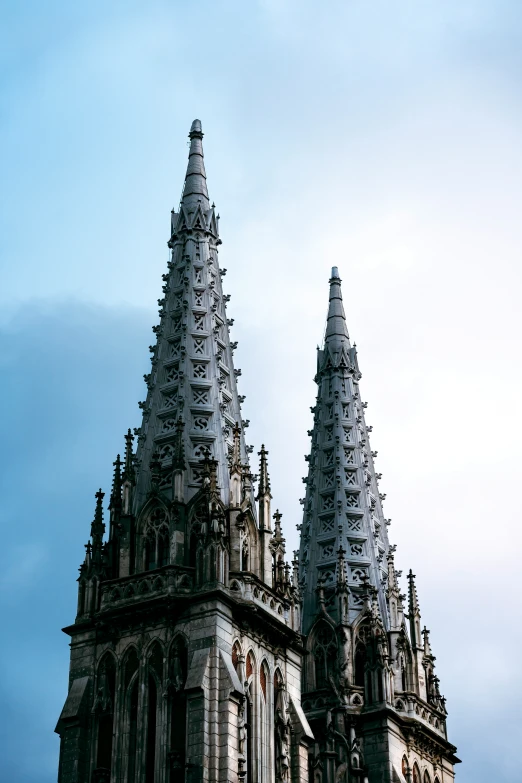 there are two very tall spires that look like they have a clock in each one