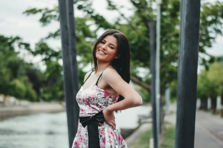 a woman standing outside smiling at the camera