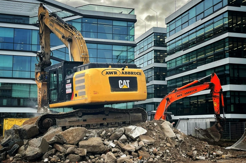 some construction equipment on top of some rocks and a building