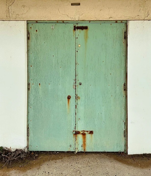 two doors one with green, one white painted on the outside