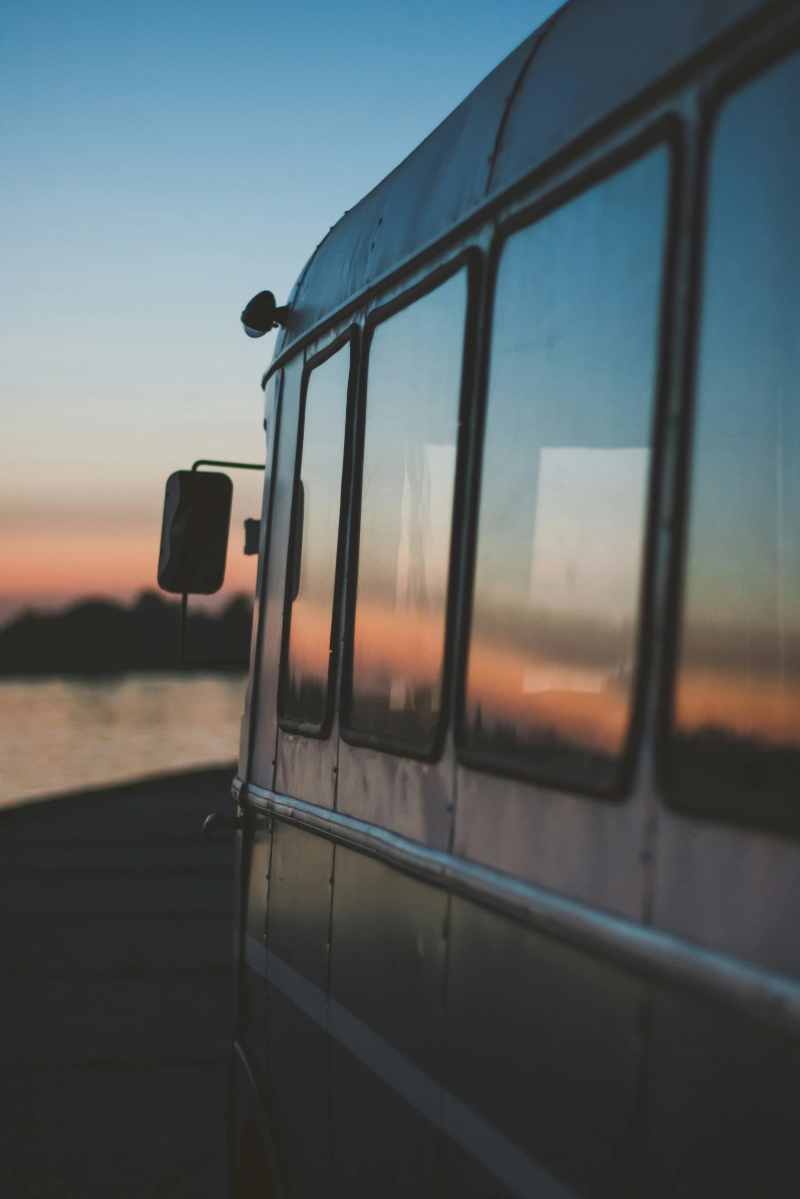 a vehicle driving on the highway with a sunset in the background