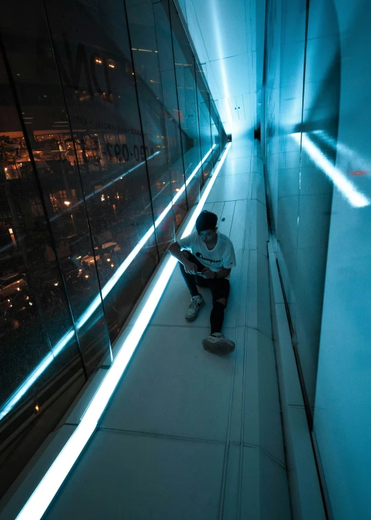 a man sitting alone with his guitar in the dark