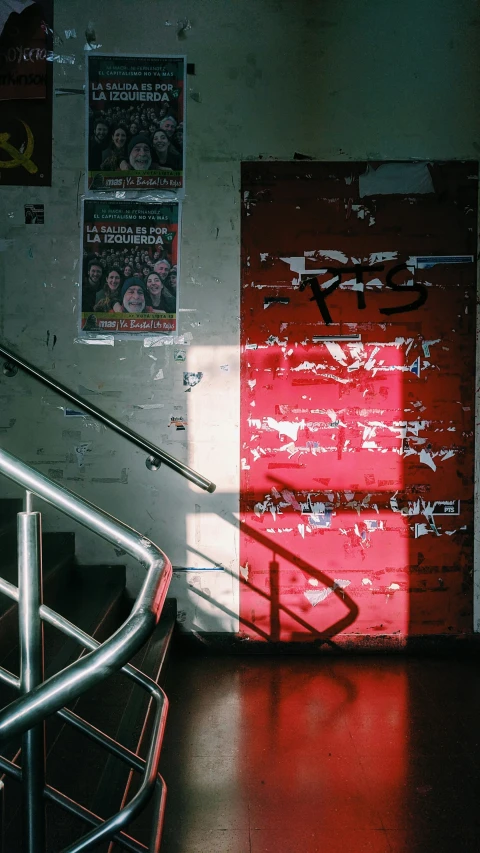 a stairwell leading to the top floor with graffiti on it