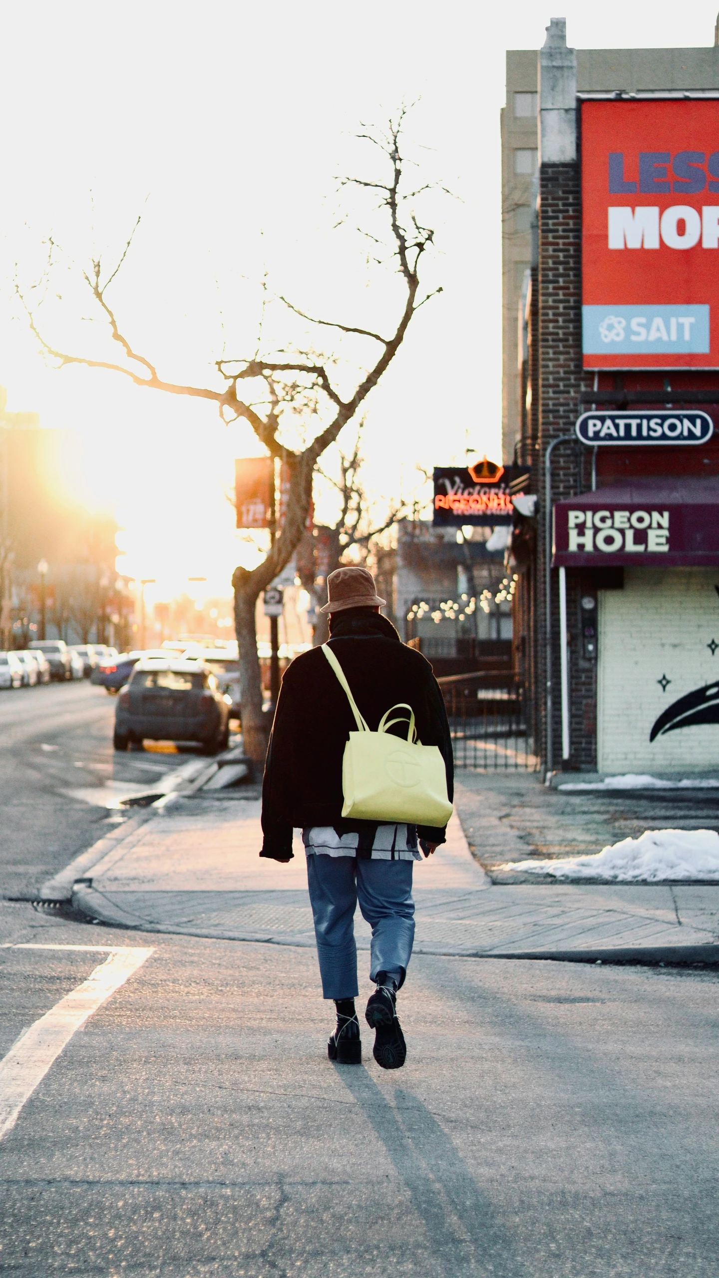 a person in black coat carrying a yellow purse