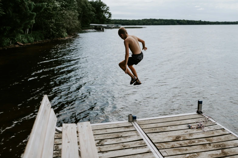a man doing a skateboard trick near a body of water
