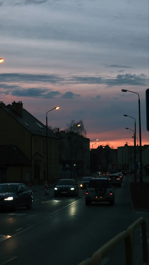 a busy street is pictured with cars going by