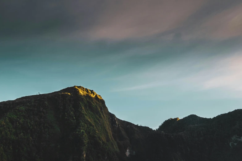 mountains are towering into the distance under cloudy skies