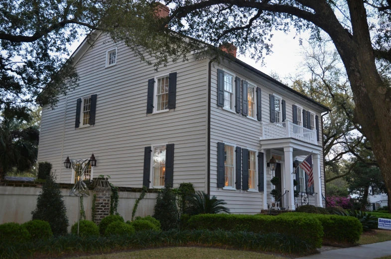 a large home with two story windows and white shutters