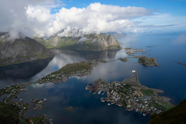 a town and a body of water under clouds