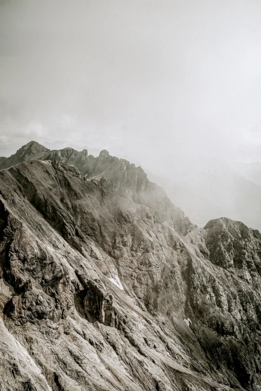 two tall mountain peaks on a cloudy day