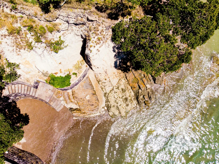 an aerial view of some water near the shore