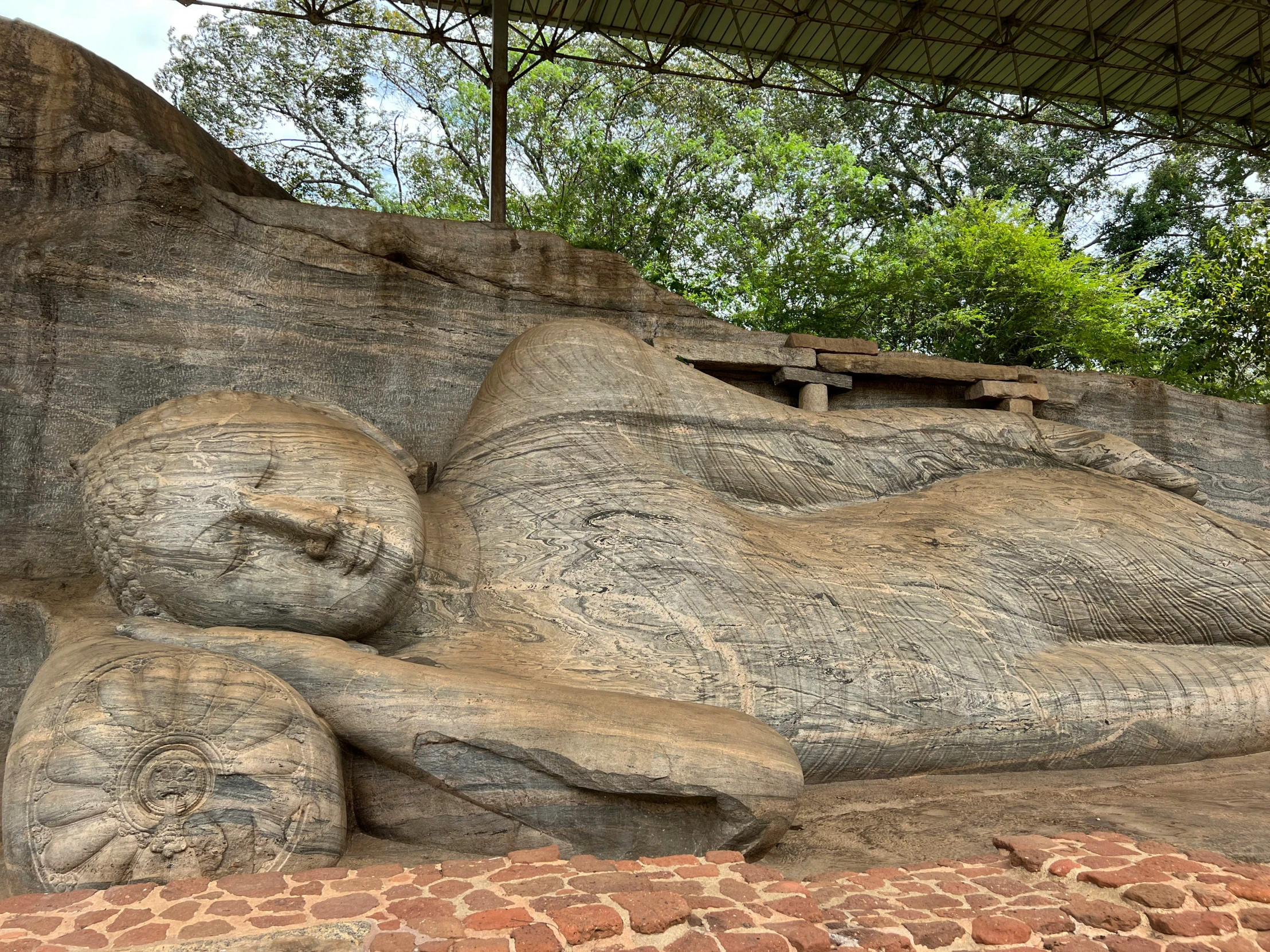 this is a stone statue with a roof