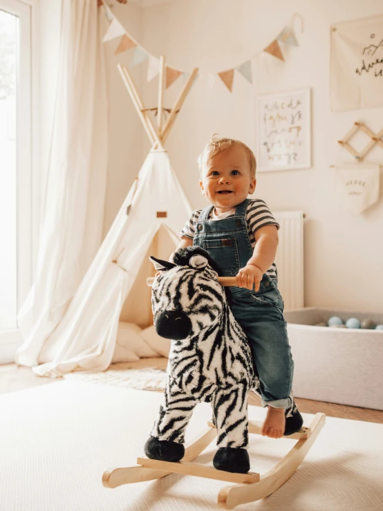 a small child playing with a plush animal on a rocking horse