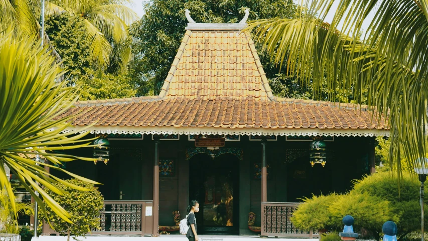 a building is shown next to trees and palm trees